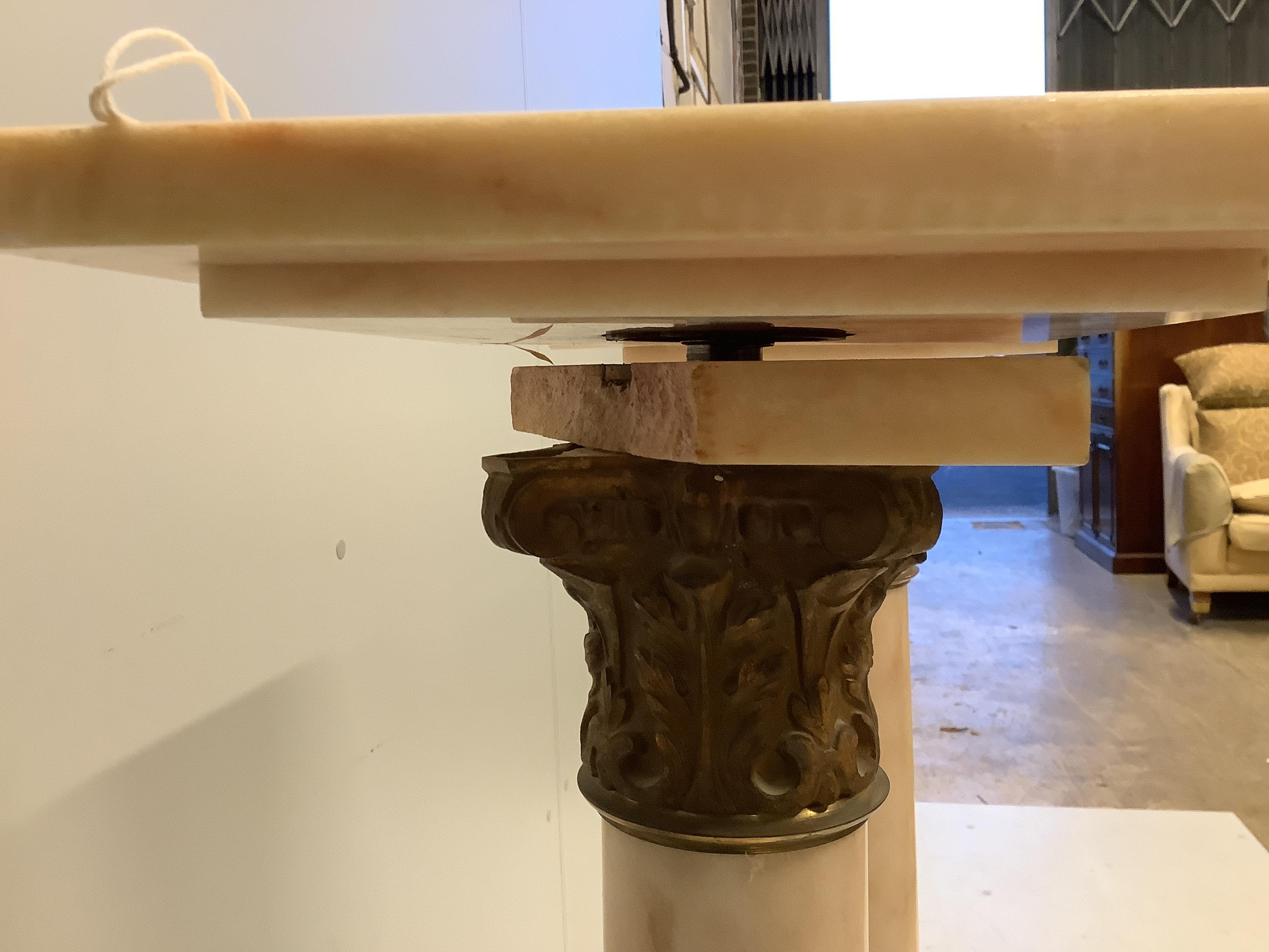 A pair of gilt metal mounted pink onyx pedestals, width 25cm, height 107cm